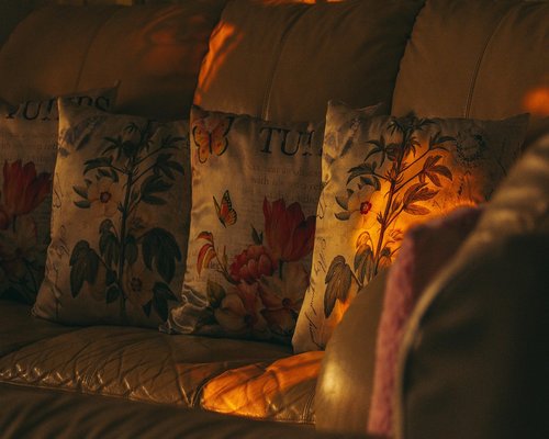 A modern cozy living room with warm interior lighting set up for a relaxing evening at home